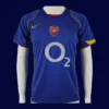front view of blue away retro football jersey (04/05) with classic trims and retro collar.