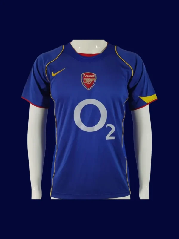 front view of blue away retro football jersey (04/05) with classic trims and retro collar.