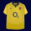 front view of yellow away retro football jersey (03/05) with bold retro accents and crew neck.