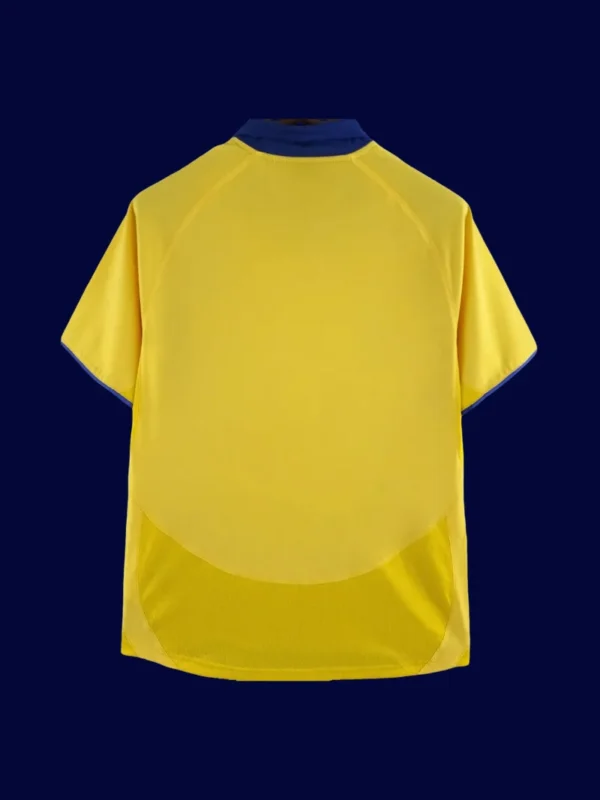 back view of yellow away retro football jersey (03/05) showing plain back ready for numbers.