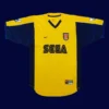 front view of yellow away retro football jersey (2000) with clean collar and retro stripes.