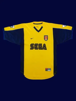 front view of yellow away retro football jersey (2000) with clean collar and retro stripes.