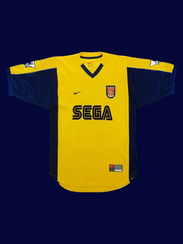 front view of yellow away retro football jersey (2000) with clean collar and retro stripes.