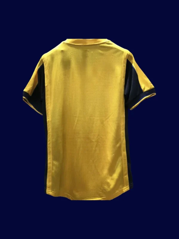 back view of yellow away retro football jersey (2000) showing smooth back panel for numbers.