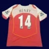 back view of red home retro football jersey (04/05) showing stitched back and number area.