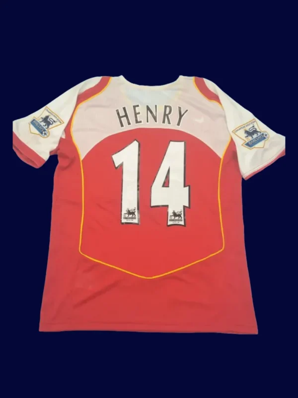 back view of red home retro football jersey (04/05) showing stitched back and number area.