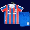 Crystal Palace Home Kids Kits 25/26 front with mini crest and youth fit.