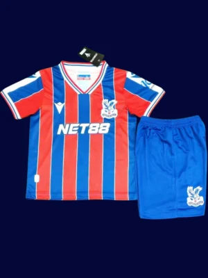 Crystal Palace Home Kids Kits 25/26 front with mini crest and youth fit.