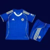 Leicester City Home Kids Kits 25/26 front with mini crest and youth-friendly fit.
