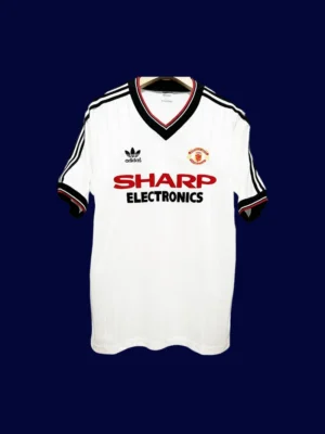 front view of Manchester United away white retro jersey (82/83) with vintage collar and trim.