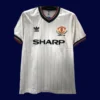 front view of Manchester United FA Cup Final retro jersey (1983) in red with classic trims.