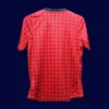 back view of home red player-fit retro jersey (12/13) showing tapered back and number panel.