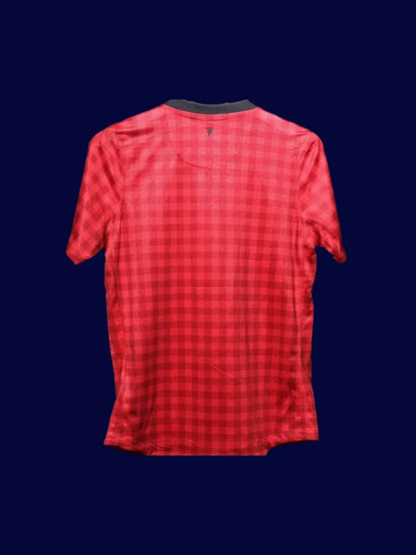 back view of home red player-fit retro jersey (12/13) showing tapered back and number panel.