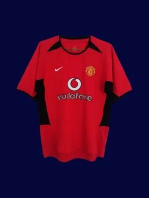 front view of Manchester United home retro jersey (02/04) in red with traditional collar.
