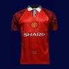 front view of Manchester United home retro jersey (96/97) in red with classic trims.