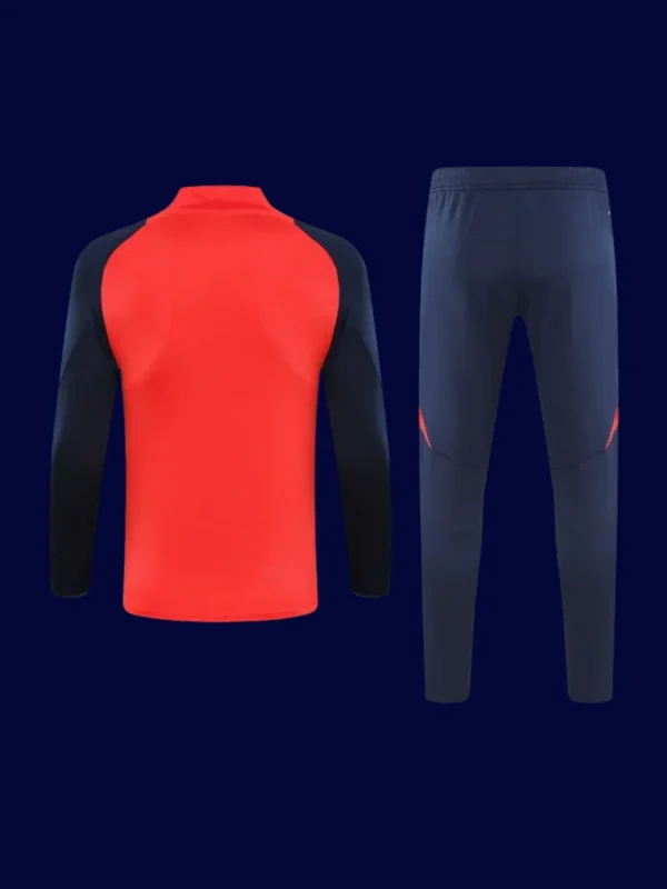 back view of red Manchester United tracksuit (2025) showing clean back panel and ergonomic seams.