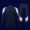 back view of black tracksuit top showing ventilation channels and tapered hem (24/25).