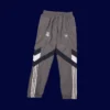 back view of grey windbreaker kit showing ventilation panels and tapered hem (24/25).