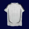back view of white home retro football jersey (06/07) showing reinforced back and tapered hem.