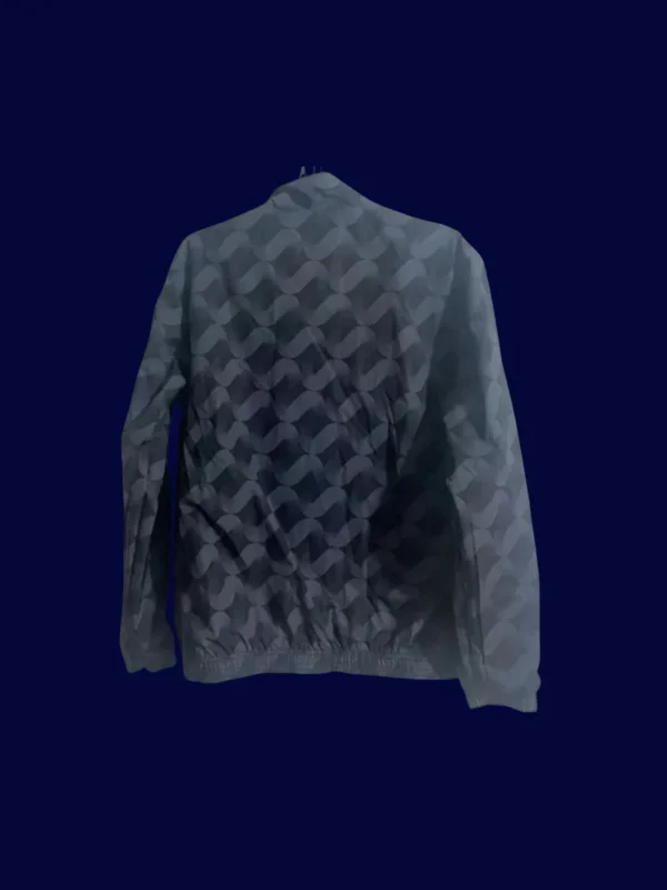 back view of reversible windbreaker displaying reverse print and hood detail (24/25).