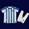 Real Sociedad Home Kids Kits 25/26 front with mini crest and child-friendly fit.