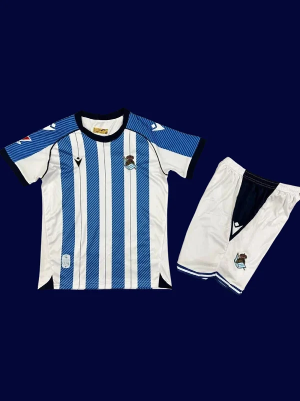 Real Sociedad Home Kids Kits 25/26 front with mini crest and child-friendly fit.